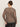 A person with their hair in a bun and glasses wears the Sanctuary Clothing long sleeve perfect mesh tee French Kitty (extended sizing), standing with their back to the camera against a plain light background.