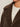 Close-up of a person wearing the Sanctuary Clothing Colette Fur Jacket Choco Chip in extended sizing over a cream knit sweater, with only the lower half of their face visible.