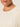 Close-up of a person wearing the nomad cable popover chalk sweater from Sanctuary Clothing, featuring a diamond cable-knit pattern. The image highlights the textured knit and part of the person's chin and lips. Extended sizing available.