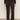 A person wears Sanctuary Clothing's Corduroy Hayden Bootcut Pant in Semi Sweet (extended sizing) with front patch pockets, paired with a black long-sleeve top and black ankle boots, against a light background.