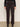 A person wears Sanctuary Clothing's Corduroy Hayden Bootcut Pant in Semi Sweet (extended sizing) with front patch pockets, paired with a black long-sleeve top and black ankle boots, against a light background.