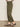 A person stands on a concrete floor, shown from the side, wearing Sanctuary Clothing™s boyfriend utility high rise pant in kalamata and leopard print Mary Jane flats.