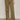 A person wearing Sanctuary Clothing’s cruiser full length pant in dirty martini, featuring wide legs and large front pockets, stands on a gray floor. Only the lower half and their white sneakers are visible.