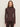 A woman with straight brown hair wears the Sanctuary Clothing ls mock essential top in semi sweet, a fitted long-sleeve high-neck dark brown top, paired with dark pants, standing against a plain light background and facing forward.