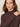 A woman with long brown hair wears the Sanctuary Clothing ls mock essential top in semi sweet, looking at the camera with her left hand on her right shoulder against a neutral background.