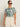 A woman wearing Sanctuary Clothing's the perfect tee green oasis (extended sizing) and high-waisted cream pants stands against a light background, with one hand in her pocket.