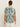 A person with dark hair in a low bun wears Sanctuary Clothing's the perfect tee green oasis extended sizing with cream pants, shown from the back against a plain light background.