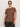 A woman in Sanctuary Clothing's "the perfect tee boheme" for extended sizing, featuring a brown floral short-sleeve top, dark sunglasses, and dark pants stands against a plain light background.