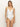 A person stands against a neutral background wearing the Sanctuary Clothing "refresh rib v wire mio white," a one-piece swimsuit with thin straps and a deep V neckline.