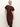 A woman with blonde hair models the Sanctuary Clothing cinched waist t shirt dress in chicory, featuring short sleeves and a midi length, standing against a plain light background with one hand on her hip.