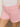 Close-up of someone in Sanctuary Clothing's arden denim short washed cherry blossom, featuring pockets and belt loops. They wear a white top, with one hand on their hip, flaunting light pink nail polish.