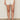 A person wears Sanctuary Clothing's voyage short in bleached white with a white textured top and beige woven sandals, standing against a plain background with their hands relaxed by their sides.