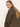 A woman with long straight blonde hair wears the Sanctuary Clothing barn jacket in burnt olive, looking over her shoulder at the camera against a plain light background.