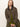 A woman with straight, light brown hair models the Sanctuary Clothing barn jacket in burnt olive over green separates, sitting against a plain background and looking directly at the camera with a neutral expression.