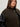A woman with long brown hair wears the Sanctuary Clothing club varsity jacket in midnight olive (extended sizing), featuring black leather sleeves and silver buttons, standing against a neutral background.