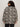 A person with curly hair wears sunglasses and the Sanctuary Clothing soiree barn jacket striking zebra extended sizing, standing with their back to the camera against a plain light background.