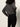 A person with curly hair is shown from the back, wearing a loose gray sweater and Sanctuary Clothing's runway legging black pants against a plain light background.