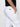 A person stands sideways with one hand in the front pocket of the rebel pant in brilliant white by Sanctuary Clothing, featuring side and back pockets and a visible Sanctuary Clothing brand tag above the back pocket.