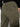 A close-up of a person in Sanctuary Clothing's rebel pant hiker green, featuring a back buttoned pocket with a black œSanctuary� label. The person pairs the pants with a black top.