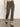 The lower half of a person is shown wearing Sanctuary Clothing's carnaby kick crop leggings in french kitty, standing on a gray floor against a plain off-white background.