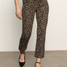 The lower half of a person is shown wearing Sanctuary Clothing's carnaby kick crop leggings in french kitty, standing on a gray floor against a plain off-white background.