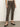 A person wears Sanctuary Clothing's carnaby kick crop leggings in french kitty print with black ankle-strap heels, standing against a neutral wall; only the body from shoulders down is shown.