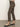 A person models Sanctuary Clothing's carnaby kick crop leggings in the french kitty print with black strappy kitten heels, standing on a brown floor against a plain light wall; only their lower half is visible.