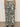 A person stands facing away, wearing the soft trouser green oasis from Sanctuary Clothing�high-waisted, wide-leg, loose-fitting pants in extended sizing. The background is plain and neutral.