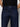 A person wears Sanctuary Clothing's the marine magnetic high-waisted dark blue denim jeans with orange stitching and a black shirt, standing against a plain light background. The cropped image shows only the torso and upper legs.