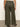 A rear view showcases a person wearing the Linen Marine Wide Leg Pant Kalamata from Sanctuary Clothing's Inclusive Collection with a beige textured top, black sandals, and a gold bracelet against a light-colored wall.