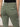A close-up of someone wearing Sanctuary Clothing's sculpted hayden bootcut pant in dark spruce, paired with a black top. The pants feature back patch pockets and a slightly fitted design, set against a plain, minimalistic background.
