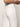 The individual is dressed in Sanctuary Clothing's arden wide leg jeans in brilliant white, featuring visible back pockets. They are paired with a striped top, hands clasped together against a plain white background.