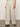 A person wearing Sanctuary Clothing's hopper straight leg flax pants and a matching top stands on a smooth concrete floor. They sport brown sandals and a thin bracelet, with a plain, light-colored wall in the background.