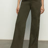 A person is wearing the rosette army pant kalamata by Sanctuary Clothing, featuring subtle embroidery on one leg. They pair it with a white top and black open-toe sandals against a plain background.