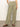 A person stands on a gray floor wearing Sanctuary Clothing's hopper straight leg cargo pants in sage, featuring large pockets. They pair them with a white shirt and brown sandals. Only the lower half of their body is visible against a plain background.
