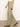 The individual is donning Sanctuary Clothing's Hopper Straight Leg Cargo in sage, featuring a loose fit and large side pockets, paired with brown sandals. They are walking on a textured gray floor, turned to the side, with a plain white background setting.