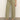 A person wearing Sanctuary Clothing's district column ankle jean bamboo—high-waisted, olive green wide-leg jeans with front patch pockets—paired with a white top and black heeled sandals, stands on a gray floor against a light background.