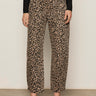 A person models the Sanctuary Clothing boyfriend utility high rise pant in French Kitty, styled with a black long-sleeve top and black sandals; shown from the shoulders down against a plain background.