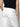Person shown from the back wearing Sanctuary Clothing's sahara tapered pant in chalk, a high-waisted white style with flap pockets and a stitched label below the waistband. The background is plain and light.