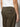 A person wears Sanctuary Clothing's sahara tapered pant in burnt olive with flap pockets and a small black label above the back pocket, paired with a white shirt. The image is cropped to show the lower back and upper legs.