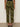 A model faces away, showing the back of Sanctuary Clothing's rio pant rambler camo against a plain light wall, paired with black heeled sandals.
