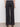 Back view of a person wearing Sanctuary Clothing's cruiser full length black pants, featuring high waist, wide legs, two large back pockets with button flaps, and an elastic waistband, shown on a neutral-colored floor.