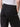 Someone wearing Sanctuary Clothing’s cruiser full length black pants with relaxed fit and flap back pockets, paired with a tucked-in white top, shown waist down from behind.
