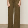 A person wearing the Sanctuary Clothing cruiser full length mossy green pants is shown from the waist down, standing against a plain beige background. The pants have front patch pockets and a wide-leg design.