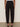 A person stands facing away, wearing Sanctuary Clothing's polished barrel pant in black—high-waisted, relaxed fit, ankle-length—paired with open-toe heels against a plain, neutral background.