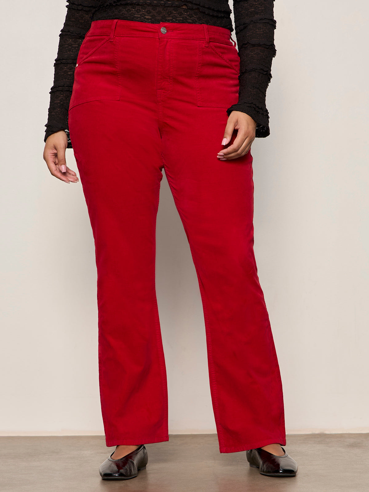 Red pants worn by a person on a plain background