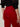 A person is shown from the back, wearing Sanctuary Clothing„¢s velveteen brook bootcut pant in cherry lacquer (petite sizing) and a black textured blouse with rolled-up sleeves, one arm relaxed at their side.