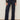 Wearing Sanctuary Clothing's marine full length jean first sight, styled with a black floral long-sleeve top and black low-heeled shoes. The individual stands against a plain light background; image cropped below the shoulders.