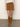 A person stands against a light wall and concrete floor, wearing a cream knit sweater, knee-high tan suede boots, and the Sanctuary Clothing briar corduroy mini skirt in bronze.