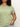 A person wearing a Sanctuary Clothing "the perfect tee" from the mosaic inclusive collection, featuring a paisley pattern and paired with light blue jeans, stands against a neutral background. They have curly hair and are holding the edge of the T-shirt.